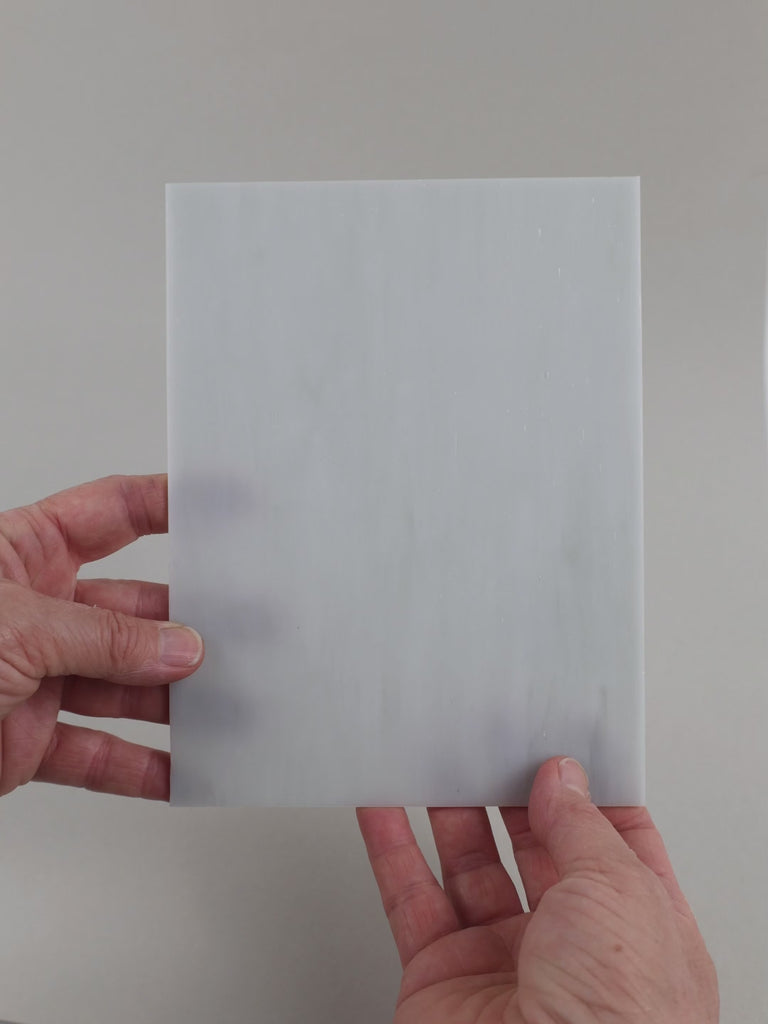 Video of the Light Grey Marble glass plate in translucent grey, 15x19cm, held up and tilted to show its pattern and transparency