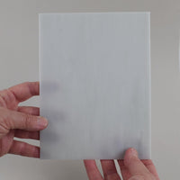 Video of the Light Grey Marble glass plate in translucent grey, 15x19cm, held up and tilted to show its pattern and transparency