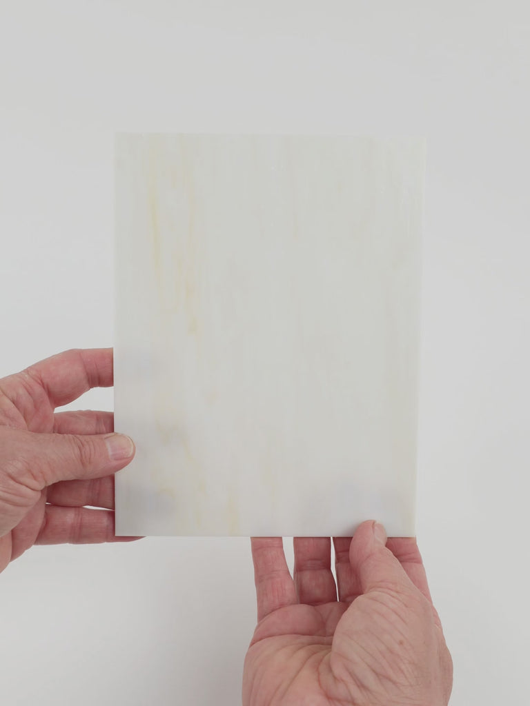 Video of the Antique Ivory glass plate in translucent beige, 15x19cm, held up and tilted to show its pattern and transparency