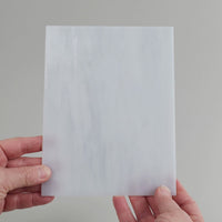 Video of the Stone glass plate in translucent grey, 15x19cm, held up and tilted to show its pattern and transparency