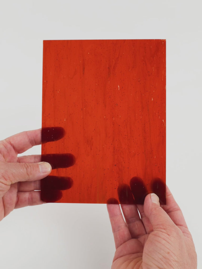 Video of the Hardwood glass plate in transparent brown, 15x19cm, held up and tilted to show its pattern and transparency