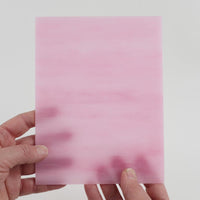 Video of the Matte Bubblegum glass plate in translucent pink, 15x19cm, held up and tilted to show its pattern and transparency